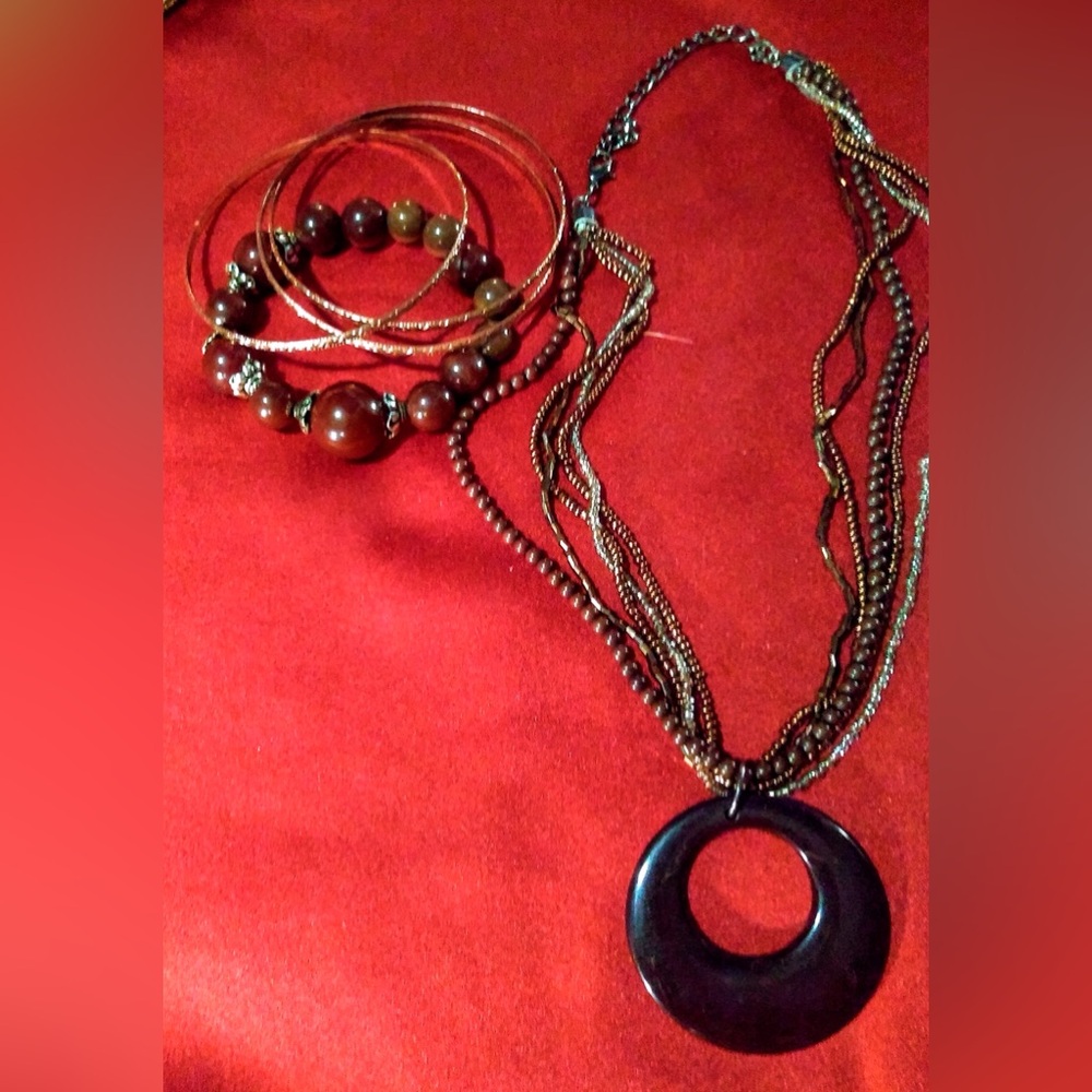 Osiris pendant on a multi strand beaded necklace w/brown and gold bangles